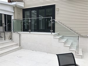 super modern contemporary glass railing outdoor stoop steps porch white tile coping searingtown